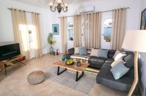 a living room with a couch and a table at Caldera Sunset Villa in Megalokhori