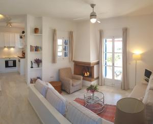 a living room with a couch and a fireplace at Naxos Beachvilla in Plaka