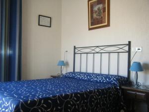 Posteľ alebo postele v izbe v ubytovaní Hostal Muriel