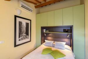 a bedroom with a bed with green walls at La Rocca Romantica in San Gimignano