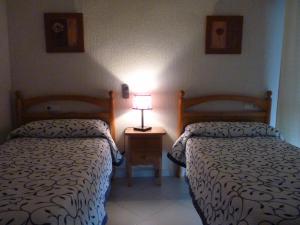 Posteľ alebo postele v izbe v ubytovaní Hostal Muriel