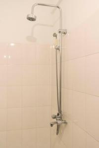 a shower with a shower head in a bathroom at Meliva Guest House Mbarara in Mbarara