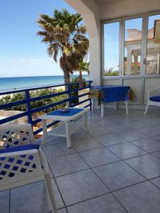 a patio with chairs and a view of the ocean at Da Giacomina in Marausa