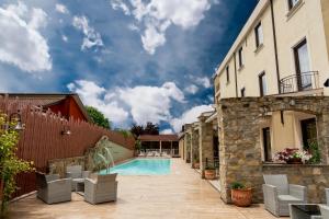 a patio with a swimming pool and a building at Hotel Villa Venus Resort & SPA in Atena Lucana