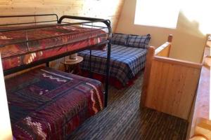 a bedroom with two bunk beds and a couch at Sequoia National Forest CabinK in Panorama Heights