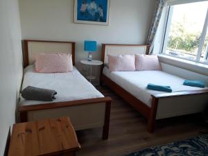 a bedroom with two beds and a window at Tisara Guest House in Galway