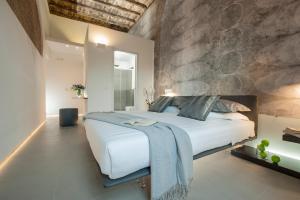 a bedroom with a large bed and a stone wall at B&B First Floor in Rome