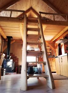 a wooden stairs in a room with a kitchen at Garpenbergs B&B, BnB in Garpenberg