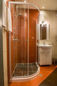 a shower with a glass door in a bathroom at Cozy One-bedroom Apartment in Night Breeze in Burgas +13 photos