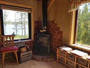 a brick stove in a room with two windows at Garpenbergs B&B, BnB in Garpenberg