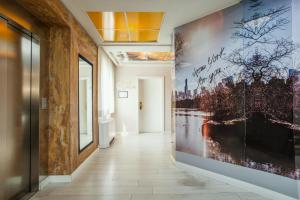 a hallway with a large painting on the wall at Diplomat Hotel & Spa in Tirana