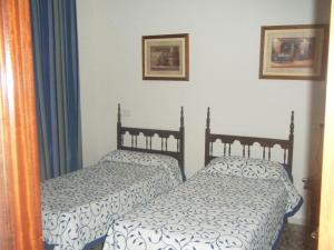 Posteľ alebo postele v izbe v ubytovaní Hostal Muriel