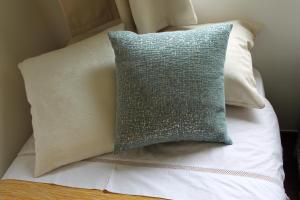 a pillow sitting on top of a bed at The Best Atlantic Ocean View in Câmara de Lobos