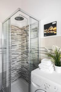 a shower in a bathroom with a glass shower stall at Galeria Home Apartments in Anguillara Sabazia