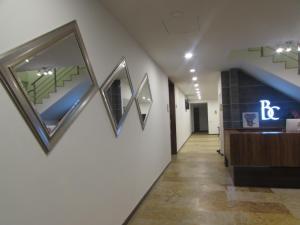 a hallway with paintings on the walls of a building at Hotel Bogota DC in Bogotá
