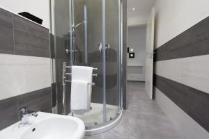 a bathroom with a sink and a glass shower at La casa di Bicio in La Spezia +25 photos