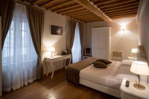 Säng eller sängar i ett rum på Le Camere Del Ceccottino
