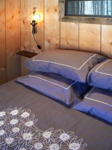 a bedroom with two beds and a lamp on the floor at Le Grenier à Luge in Les Gets