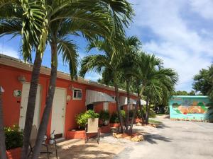 a row of palm trees in front of a building at Sea Dell Motel - Marathon in Marathon