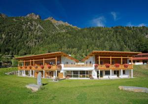 a large building in front of a mountain at Leitenhof in Val di Vizze