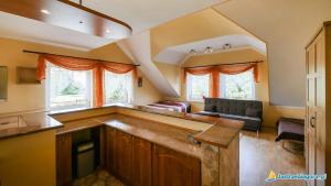 a kitchen and living room with a couch and windows at Sedna in Jastrzębia Góra +10 photos
