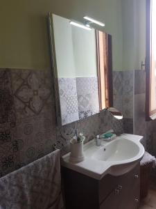 a bathroom with a sink and a mirror at Casa Brunello in La Spezia +6 photos
