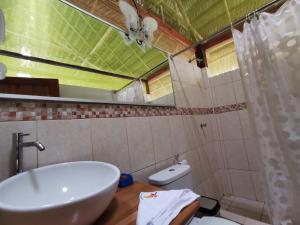 a bathroom with a sink and a toilet and a mirror at Grand Amazon Lodge and Tours - All Inclusive in Paraíso +100 photos