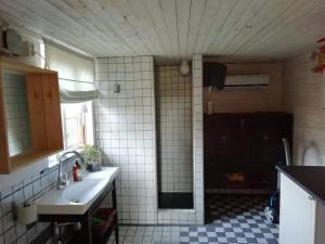 a kitchen with a sink and a tiled floor at Ynde Private Apartment in Sölvesborg