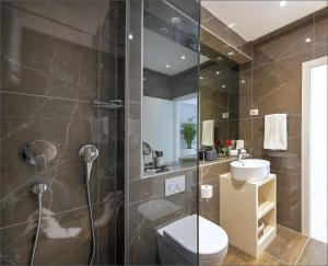 a bathroom with a shower and a toilet and a sink at Via Porto Rooms in Split