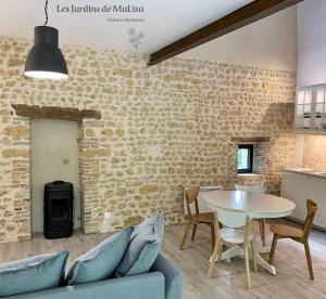 a living room with a couch and a table at Les Jardins de MaLisa - Adulte Only - in Ferrières-la-Verrerie
