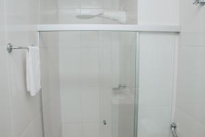 a white bathroom with a shower and a sink at Maison Collection Classic in Porto Velho +59 photos