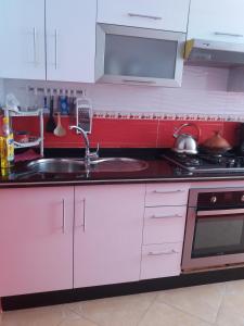 a kitchen with a sink and a stove at Apartment Nador Rif in Nador