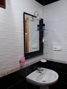 a bathroom with a sink and a mirror at Apartment Nador Rif in Nador