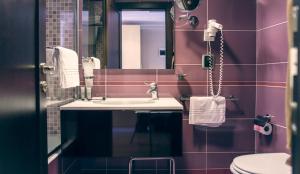 a bathroom with a sink and a mirror at Taormina Panoramic Hotel in Taormina