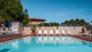 a swimming pool with lounge chairs at Taormina Panoramic Hotel in Taormina
