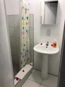a bathroom with a sink and a shower curtain at Caribbean Dream Vacation Property CD4 in Gros Islet