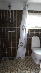 a bathroom with a toilet and a shower curtain at 140m2 Villa in Marstal in Marstal +19 photos