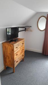 a wooden dresser with a tv on top of it at 140m2 Villa in Marstal in Marstal