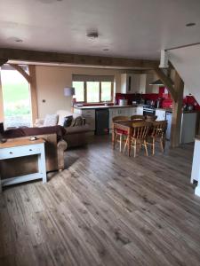 a living room and kitchen with a table and chairs at Tigh a Chabar in Lochaline