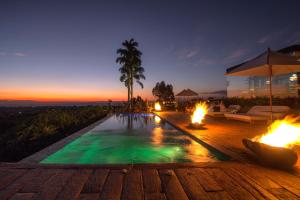 a swimming pool with fire pits in a house at Bio Habitat Hotel in Armenia