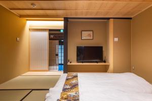 Postel nebo postele na pokoji v ubytování 京宿日和 五条 Hiyori gojo