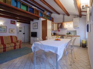 a kitchen and dining room with a white table and chairs at Casa Snomata in Senigallia
