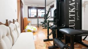 a gym with several tread machines in a room at Apartament Bardzo Popularny in Bolesławiec