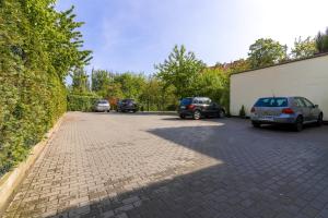 a group of cars parked in a parking lot at Nice Rooms - Pokoje Gościnne in Gdańsk