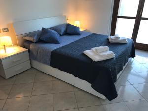Ένα ή περισσότερα κρεβάτια σε δωμάτιο στο Casavacanze estate 2