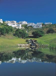 
a large body of water with houses at Quinta da Floresta – Santo António Villas, Golf & Spa in Budens
