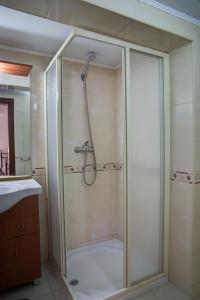 a bathroom with a shower with a glass door at CASA GRAZINA in Boliqueime