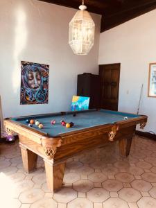 a pool table with balls on it in a room at Ocean Front Antique House, Private Beach! in Rosarito