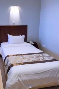 Postelja oz. postelje v sobi nastanitve Easy View Hotel Mbarara