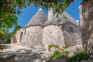 an old stone building with a tower at Casa Vacanze Riposo Del Vento in Cisternino